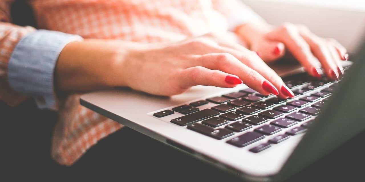 Woman typing on a laptop